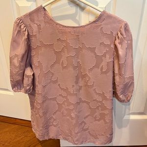 Beautiful blouse with sheer sleeves.